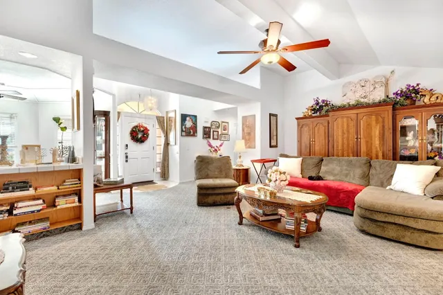 a living room with furniture and a chandelier