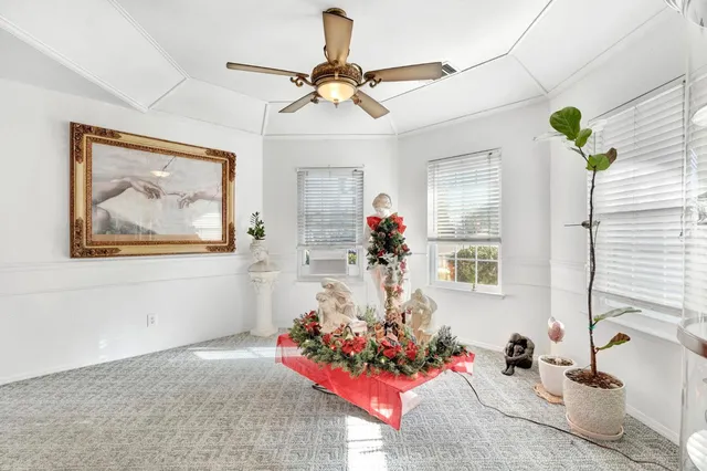 a living room with furniture and flowers