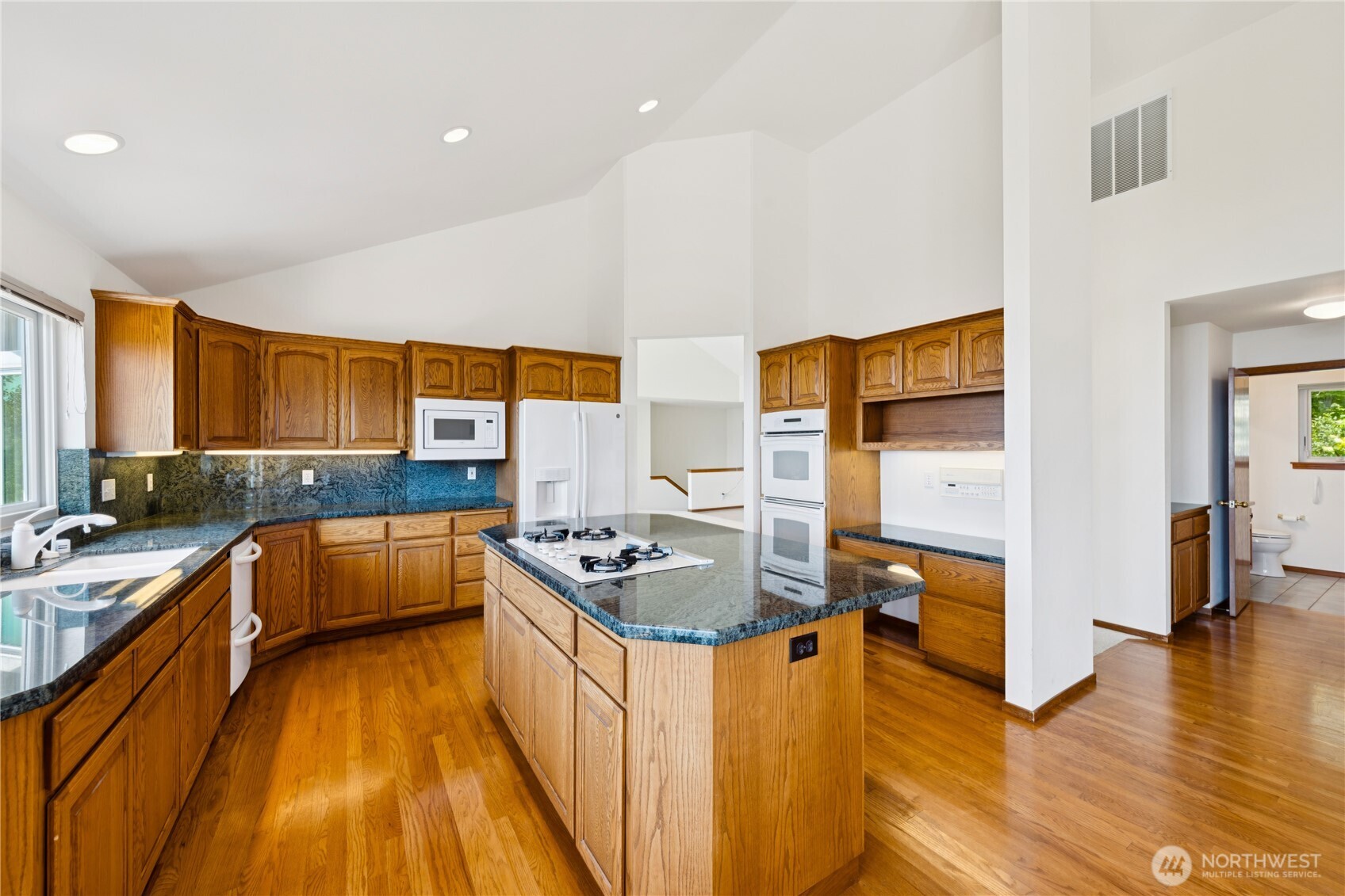 4158 Islander Way Anacortes, WA 98221 - Photo 12 of 40 a kitchen with stainless steel appliances granite countertop a stove and a refrigerator