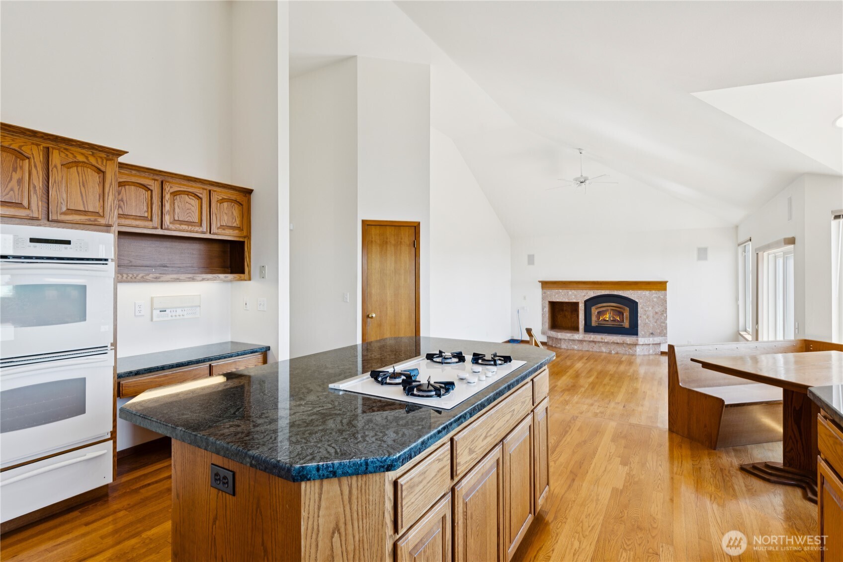 4158 Islander Way Anacortes, WA 98221 - Photo 14 of 40 a kitchen with stainless steel appliances granite countertop a sink stove and wooden cabinets