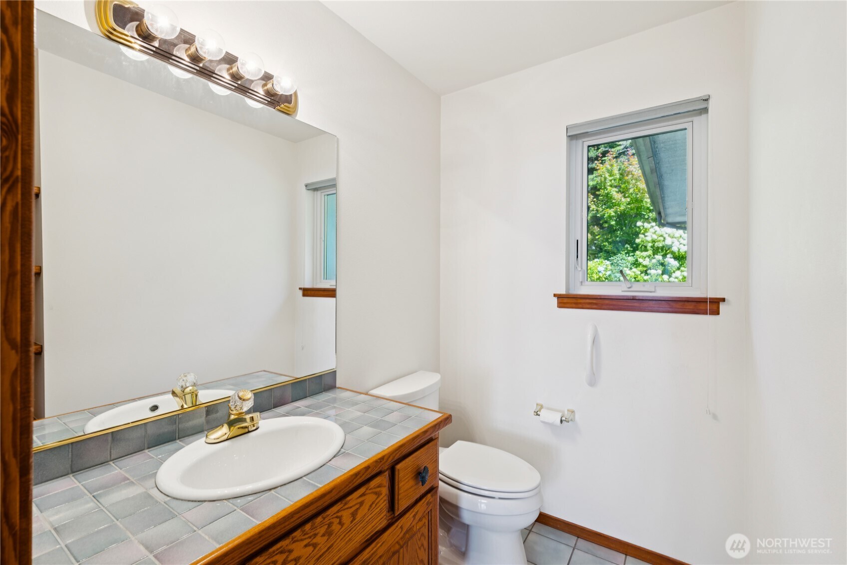 4158 Islander Way Anacortes, WA 98221 - Photo 23 of 40 a bathroom with a granite countertop sink toilet and mirror