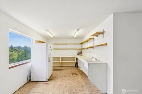 a kitchen with stainless steel appliances wooden floor and a fireplace