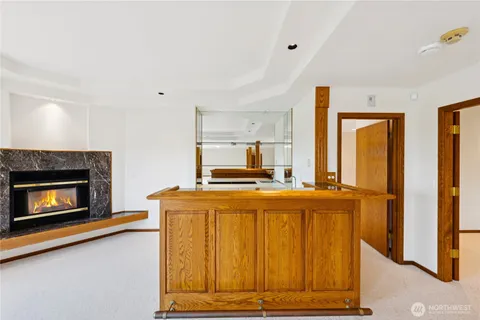 a living room with furniture fireplace and a large window