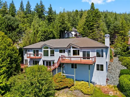 a aerial view of a house with a yard and balcony