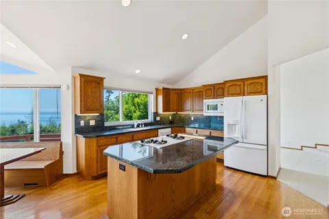 a kitchen with granite countertop a sink and a refrigerator
