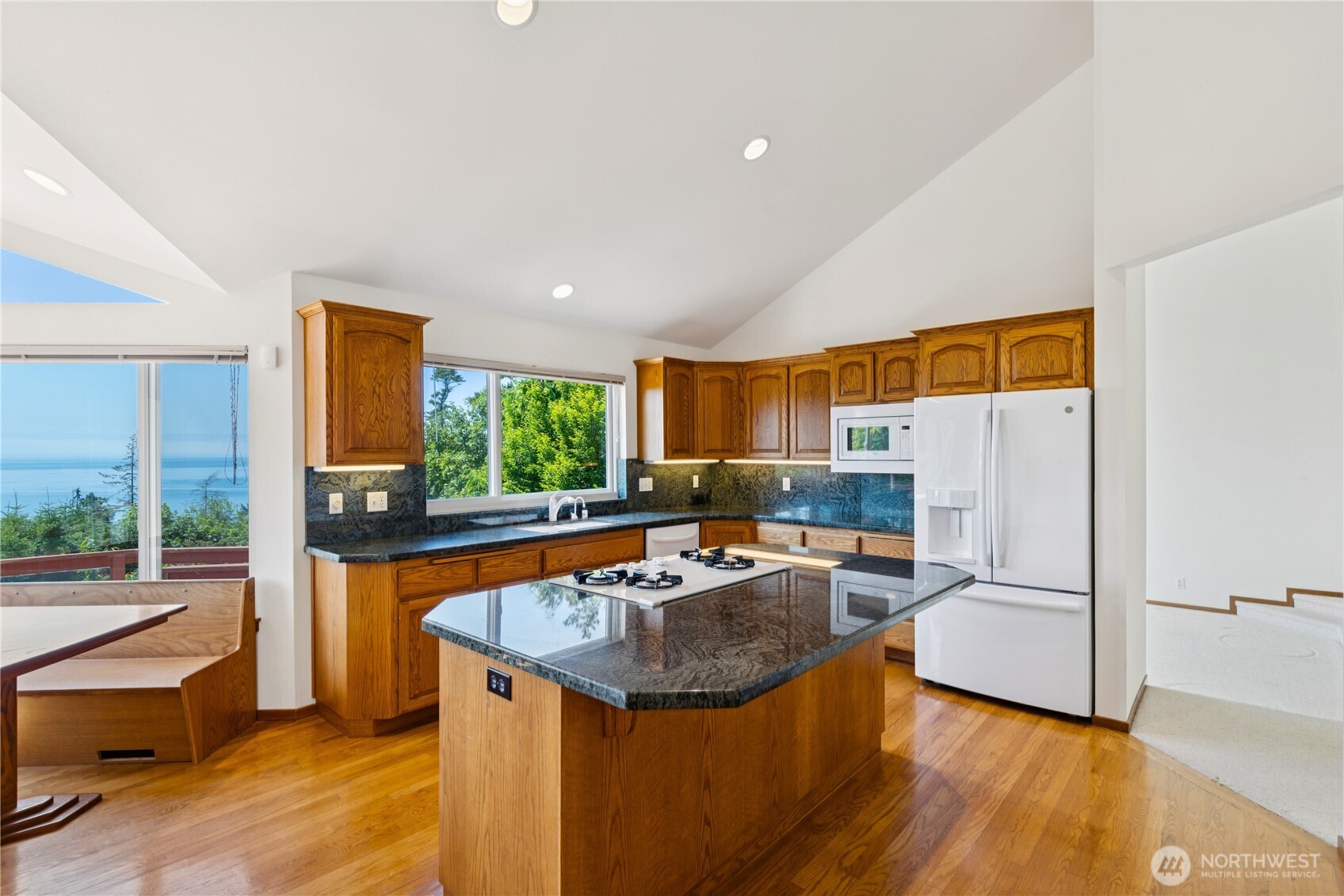 4158 Islander Way Anacortes, WA 98221 - Photo 10 of 40 a kitchen with granite countertop a sink and a refrigerator