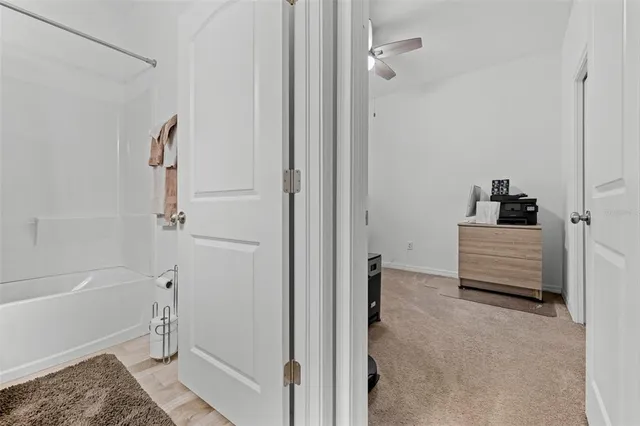 a view of a hallway with wooden floor