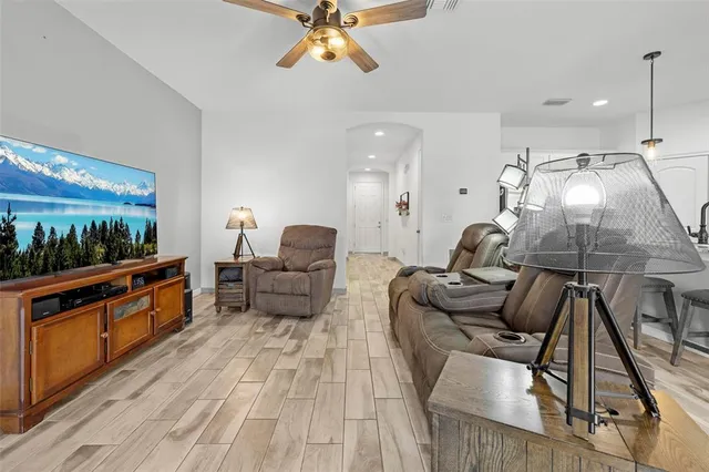 a living room with furniture and a wooden floor