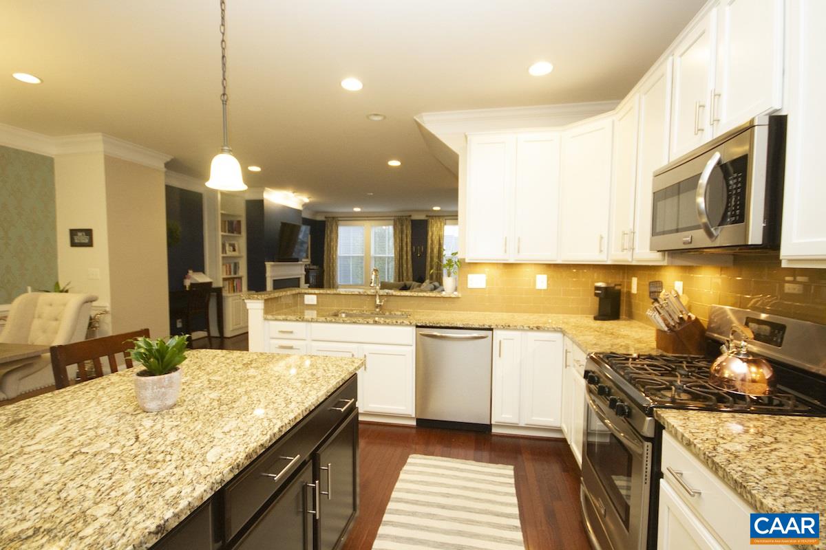 2122 Avinity Loop Charlottesville, VA 22902 - Photo 12 of 27 a kitchen with a stove sink and cabinets