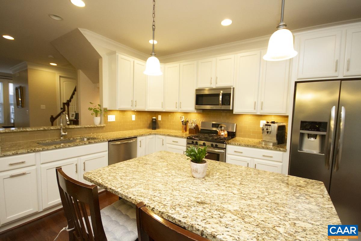 2122 Avinity Loop Charlottesville, VA 22902 - Photo 13 of 27 a kitchen with granite countertop a sink counter top space appliances and cabinets