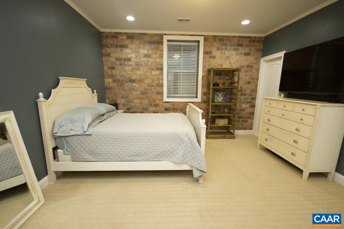 2122 Avinity Loop Charlottesville, VA 22902 - Photo 22 of 27 a bedroom with a bed and flat screen tv