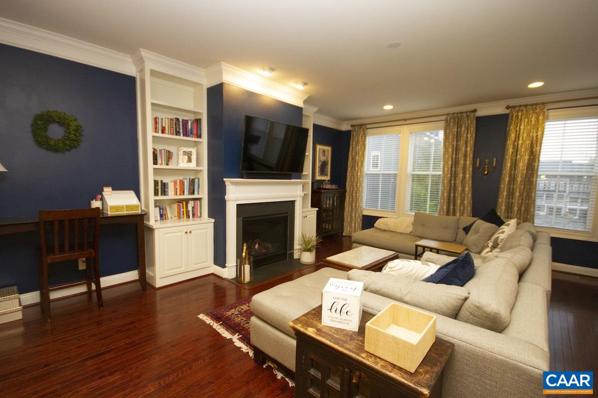 2122 Avinity Loop Charlottesville, VA 22902 - Photo 26 of 27 a living room with furniture a fireplace and a flat screen tv
