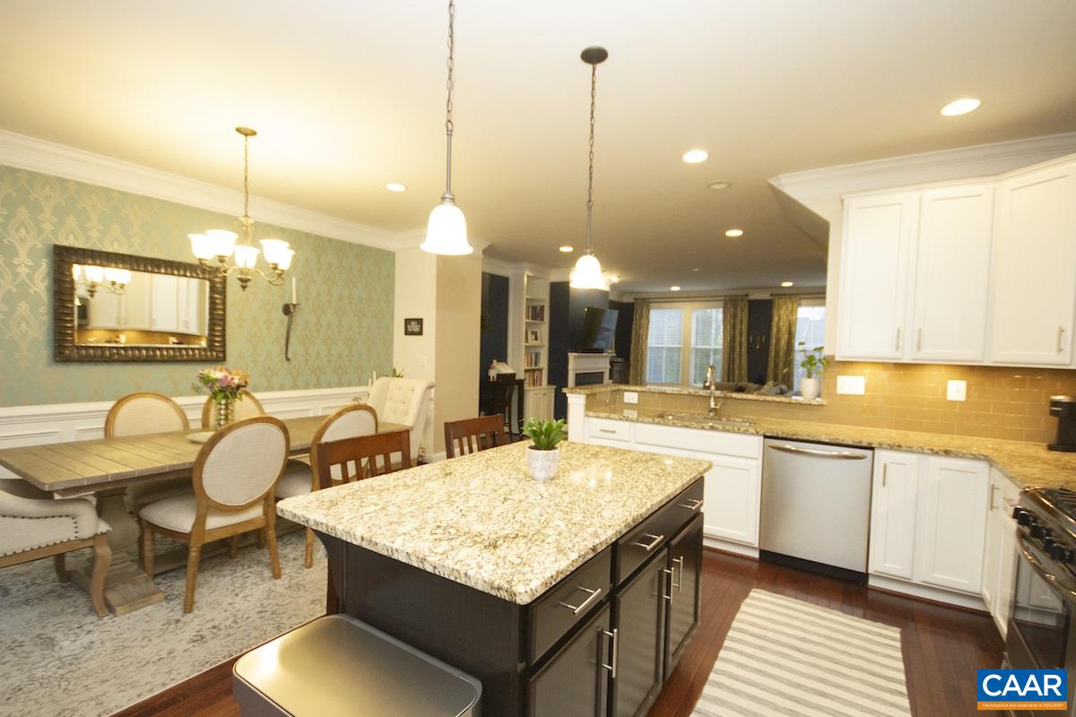 2122 Avinity Loop Charlottesville, VA 22902 - Photo 27 of 27 a kitchen with center island table and chairs