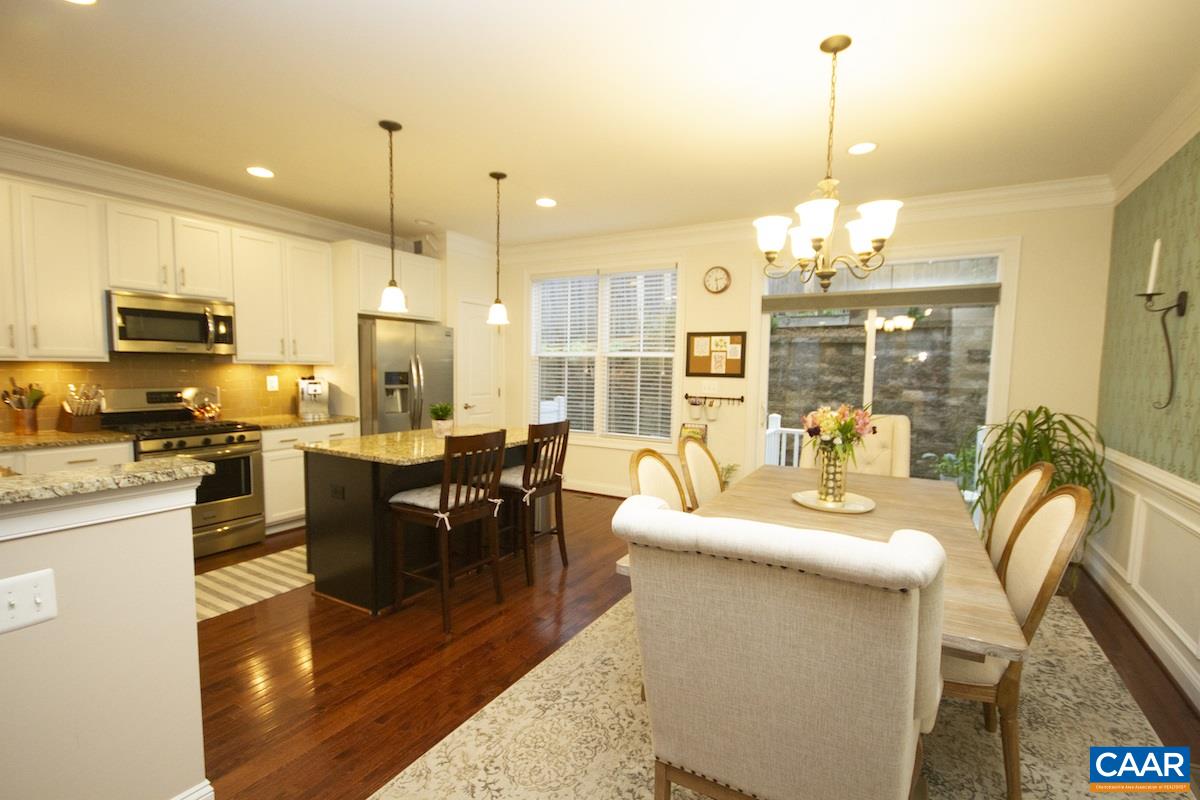 2122 Avinity Loop Charlottesville, VA 22902 - Photo 10 of 27 a living room with couches chairs and kitchen view with wooden floor