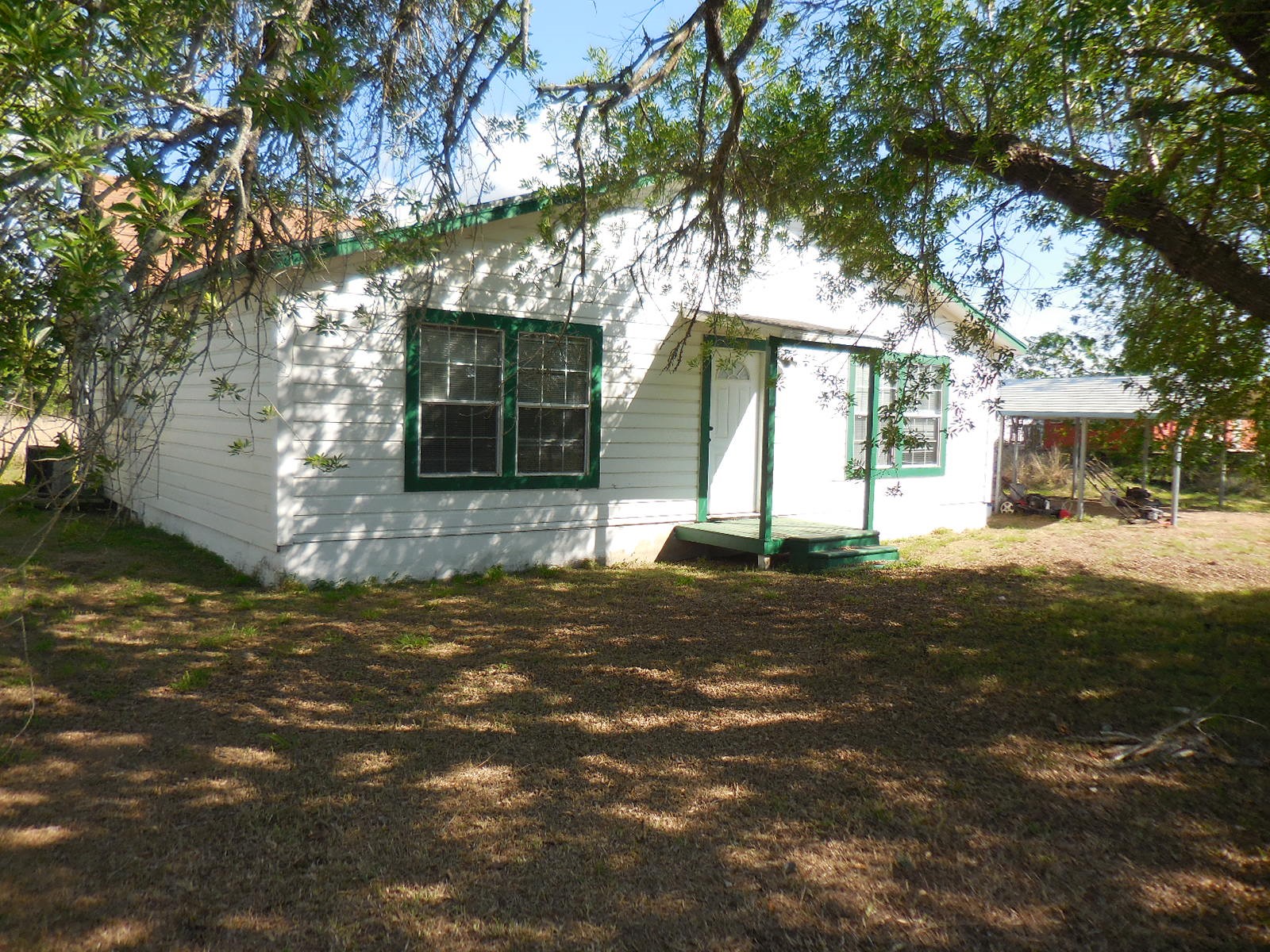 628 Austin Street West Matagorda, TX 77457 - Photo 3 of 19 a view of a white house next to a road and yard