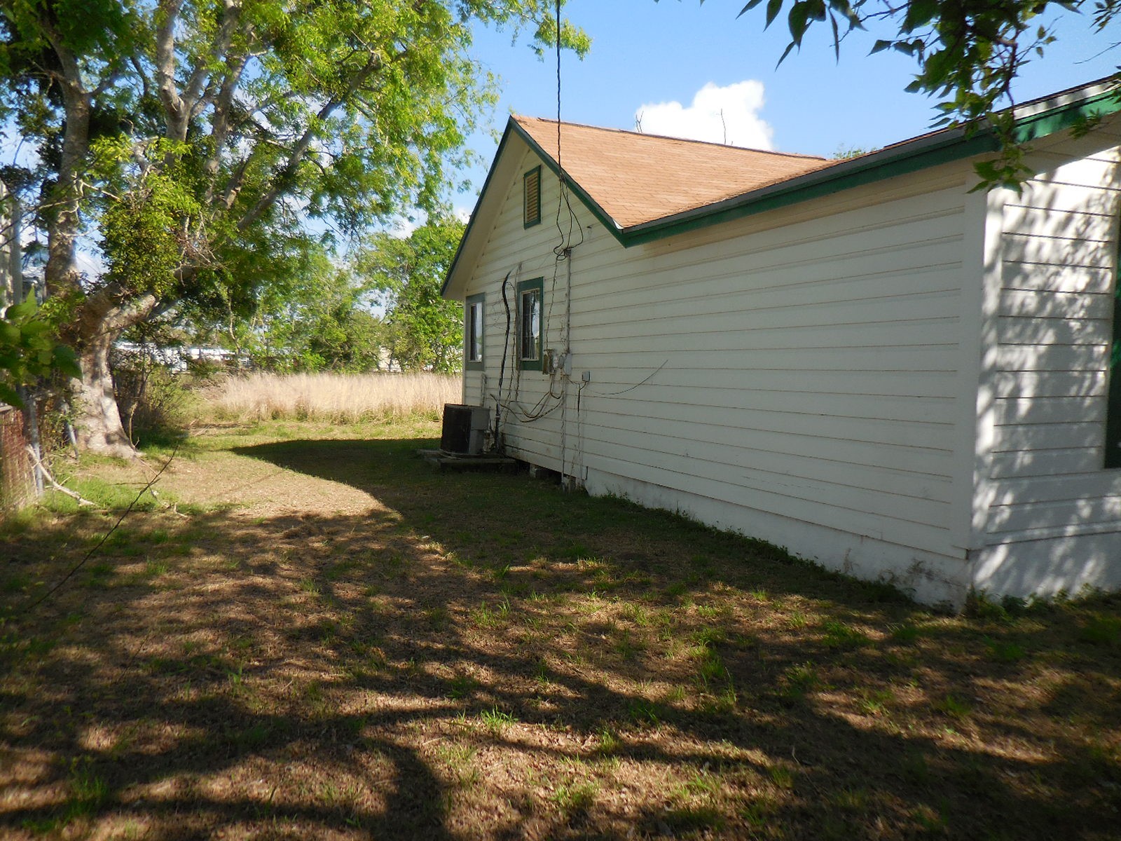 628 Austin Street West Matagorda, TX 77457 - Photo 4 of 19 a view of backyard of house with green space