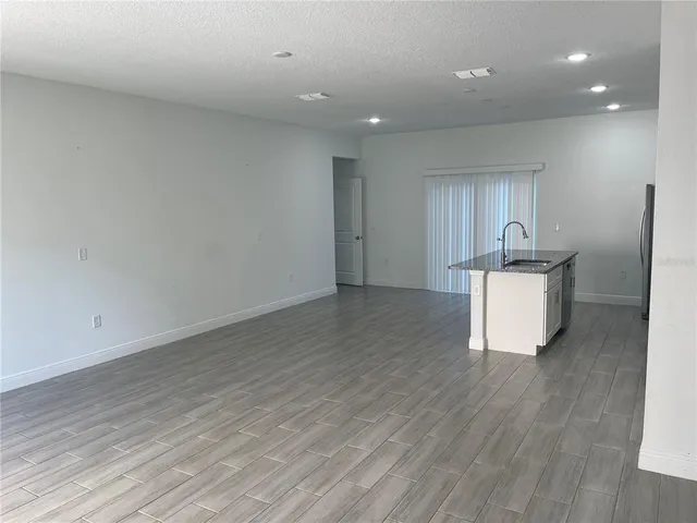 a room with wooden floor and furniture