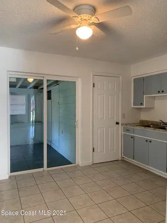a view of a kitchen with granite countertop cabinets and refrigerator