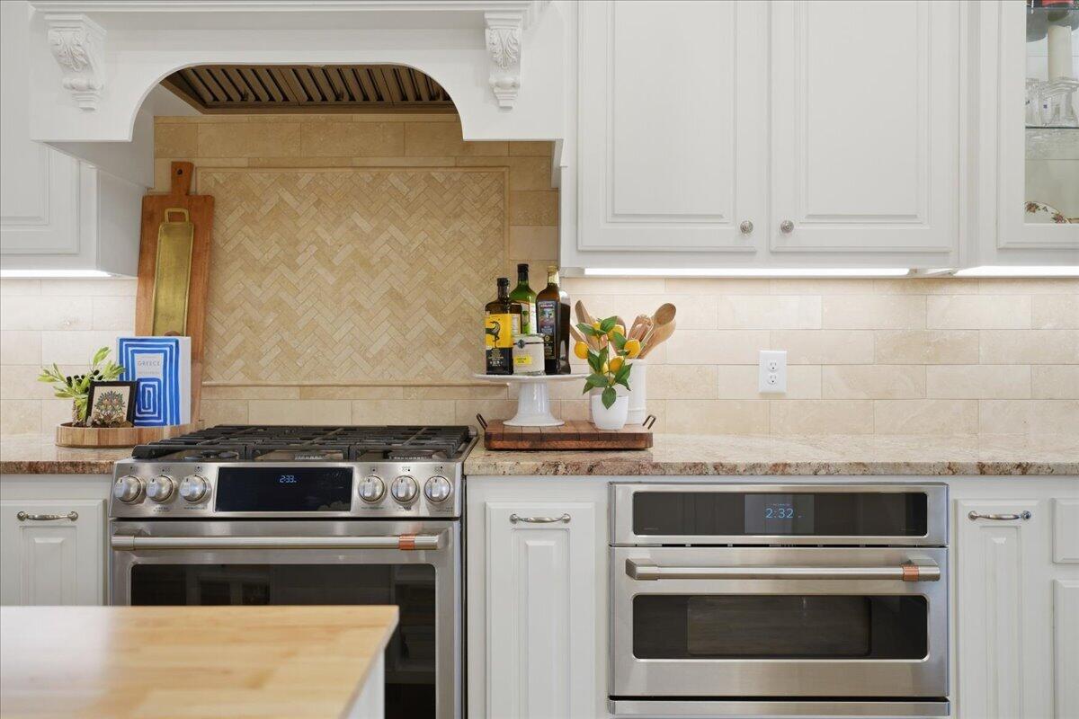 4612 100th Street Lubbock, TX 79424 - Photo 20 of 55 a kitchen with granite countertop stainless steel appliances and white cabinets