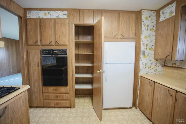 a kitchen with stainless steel appliances granite countertop a refrigerator and a stove