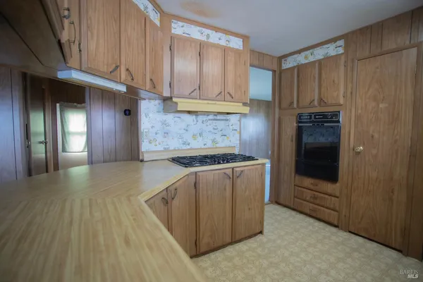 a kitchen with stainless steel appliances granite countertop a stove a refrigerator and a sink