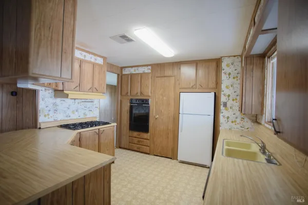 a kitchen with a refrigerator and a sink