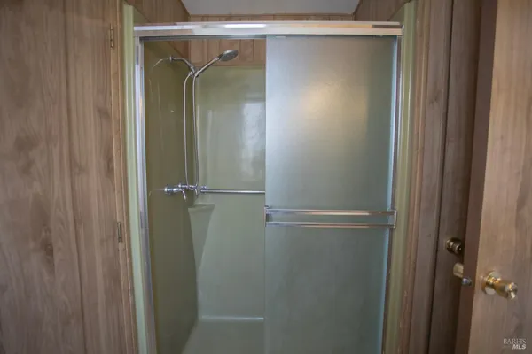 a bathroom with a glass shower door