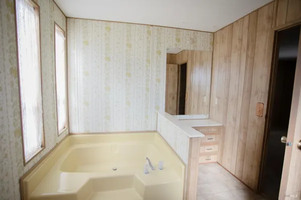 a bathroom with a tub and shower