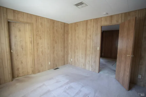 a view of a room with a wooden door
