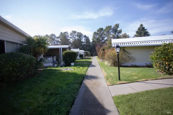 a front view of a house with a garden