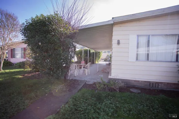 a view of backyard of house with green space