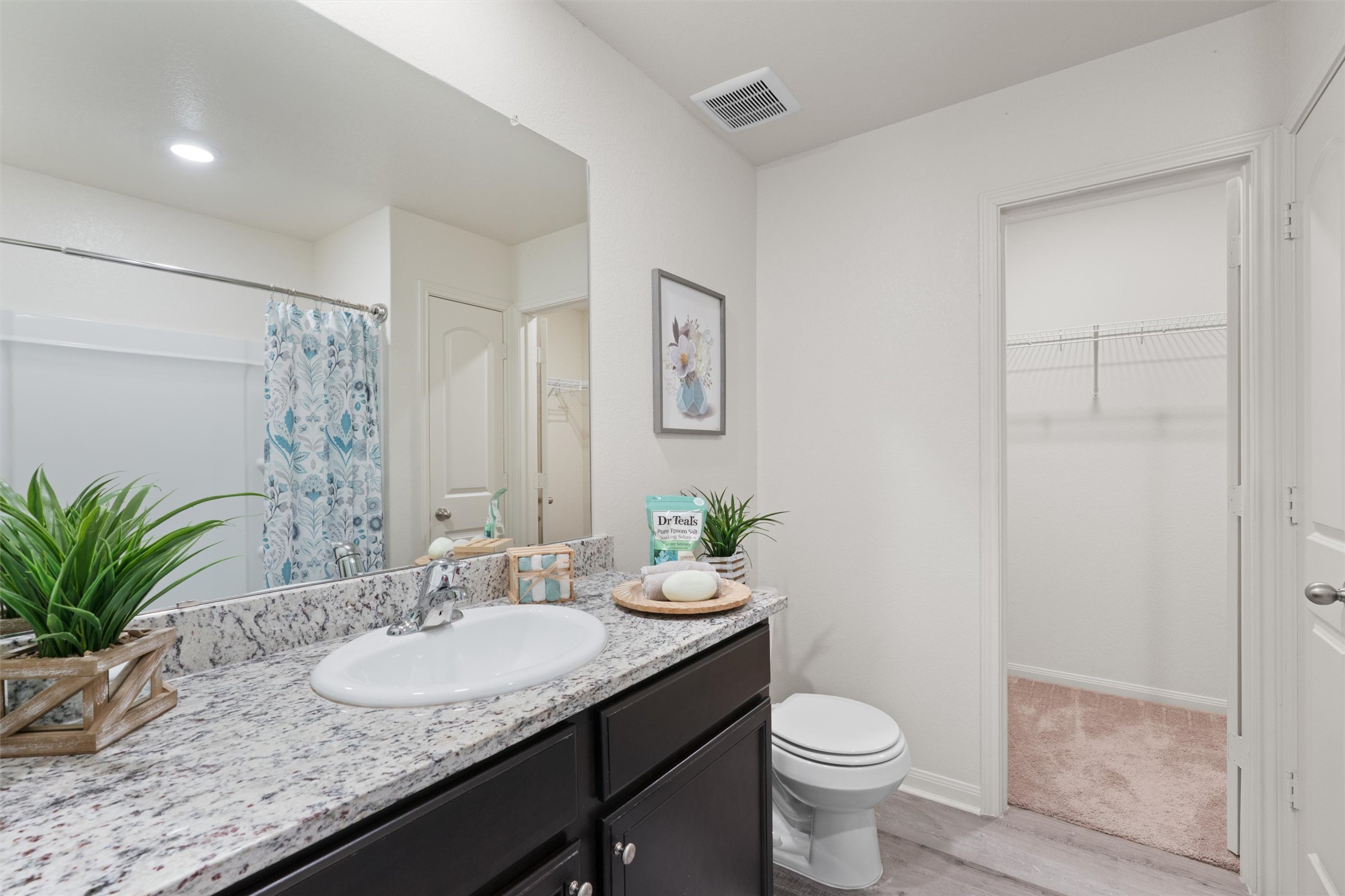 163 Niven Path, Unit 12K Jarrell, TX 76537 - Photo 18 of 31 a bathroom with a granite countertop sink toilet and a mirror