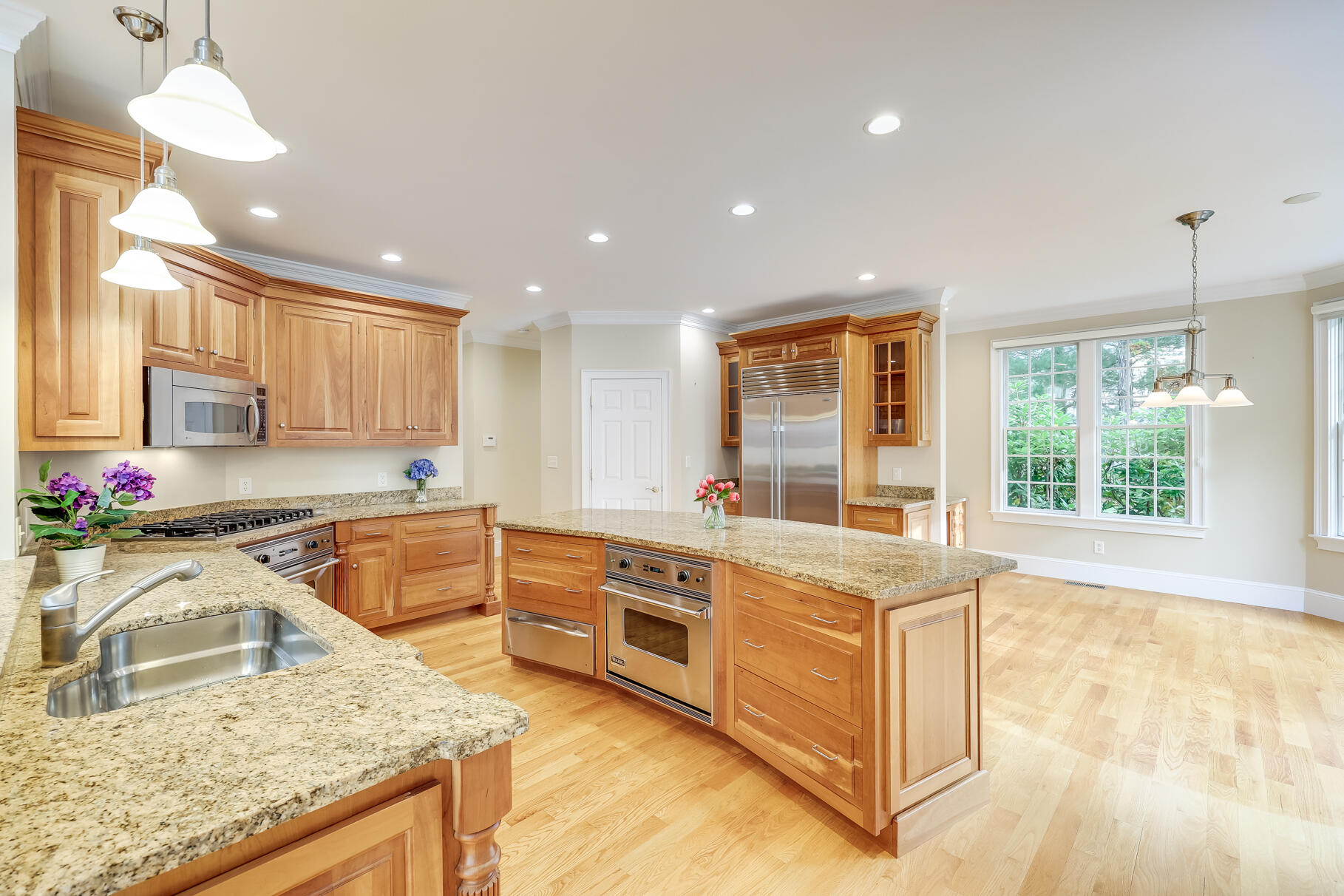 29 Reflection Drive Sandwich, MA 02563 - Photo 12 of 51 a kitchen with a stove a sink a center island and windows