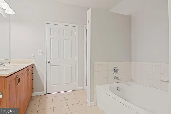 a bathroom with a tub sink and vanity