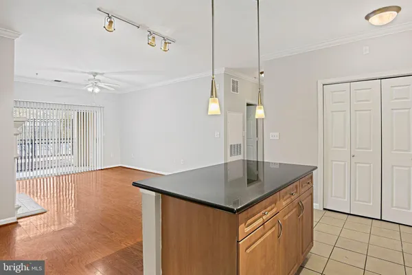a kitchen that has a sink a refrigerator and window