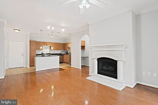 a view of a kitchen with a sink a fireplace and a window