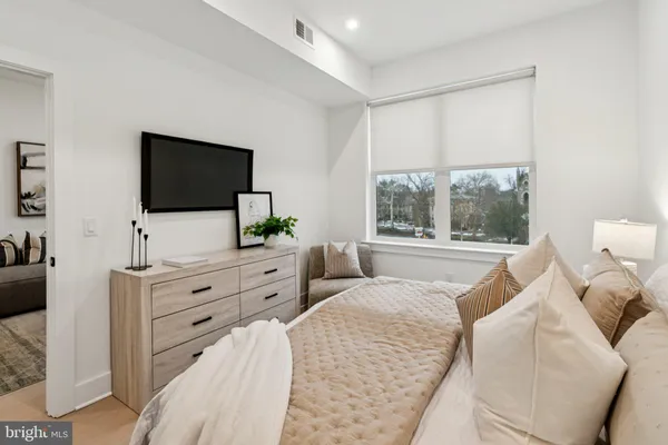 a bedroom with furniture and a flat screen tv