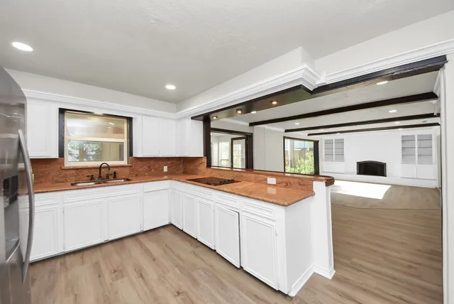 a kitchen with stainless steel appliances granite countertop a sink and cabinets