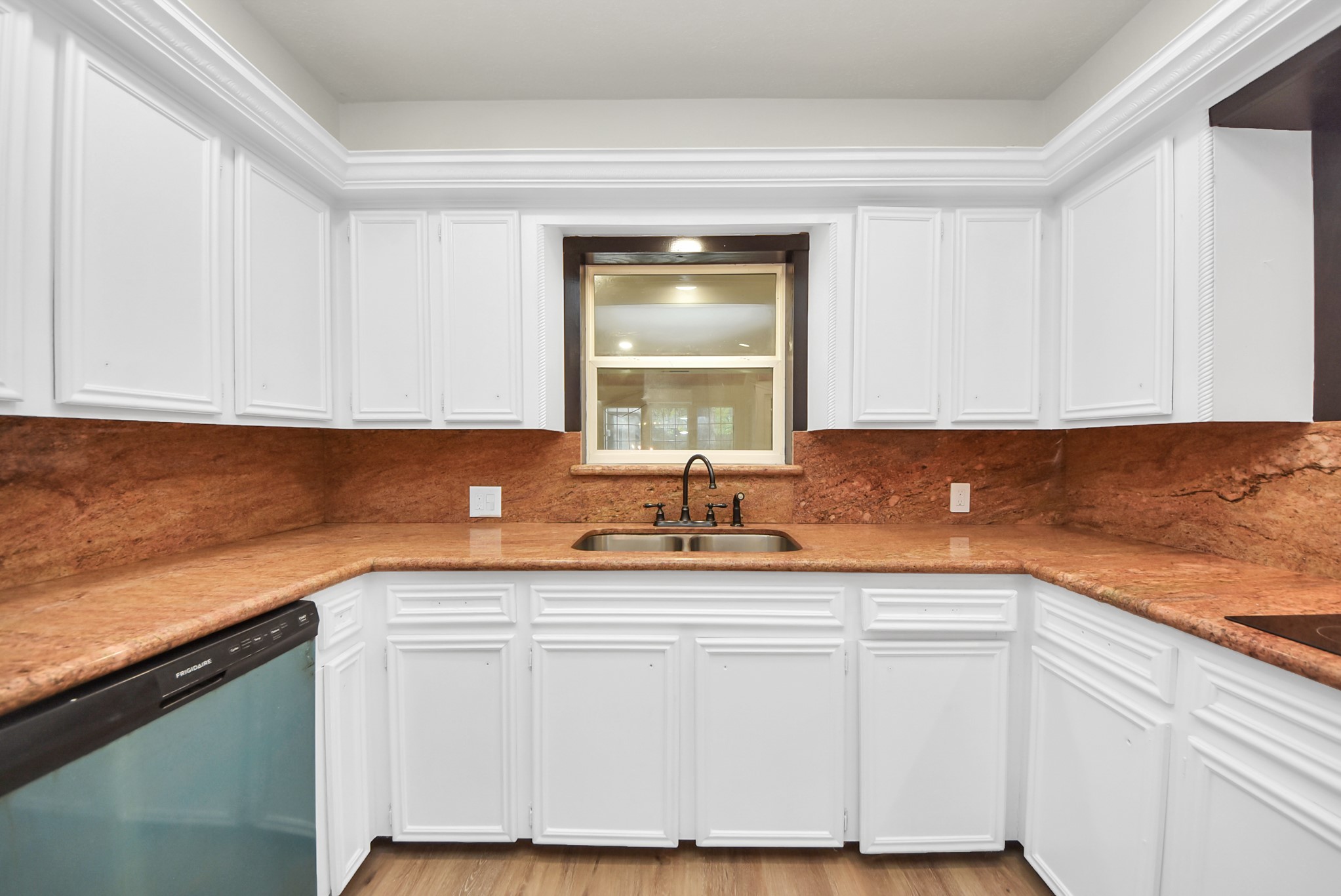 8111 Oak Moss Drive Spring, TX 77379 - Photo 17 of 49 a kitchen with granite countertop white cabinets and a sink