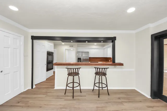 a dining room with furniture and wooden floor