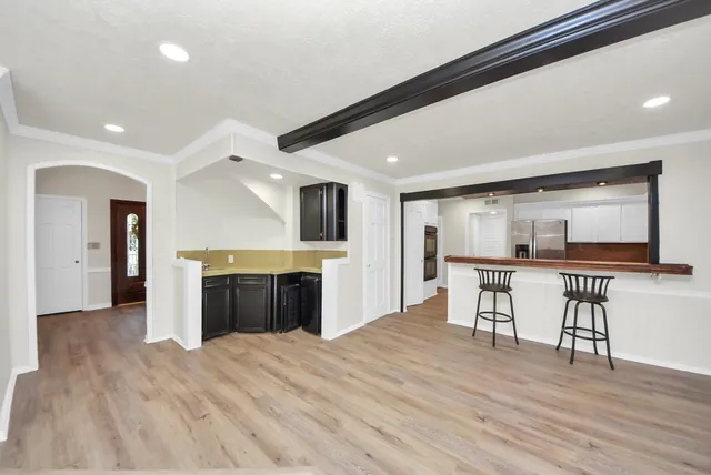 a open kitchen with sink and cabinets