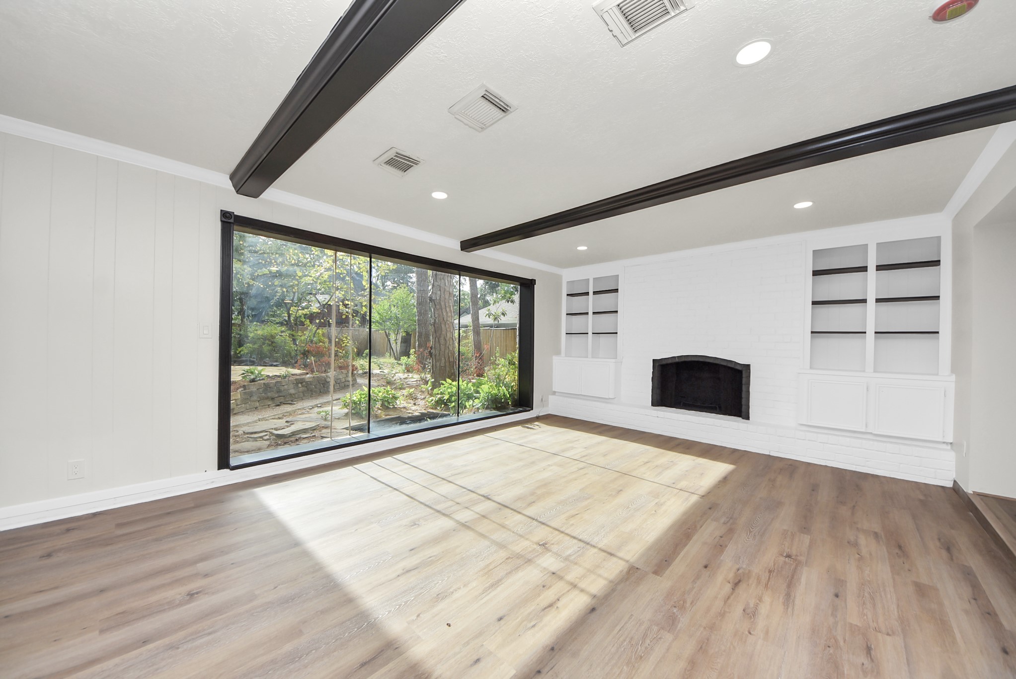 8111 Oak Moss Drive Spring, TX 77379 - Photo 22 of 49 a view of empty room with wooden floor and fireplace