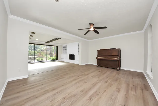 a view of room with wooden floor and ceiling fan
