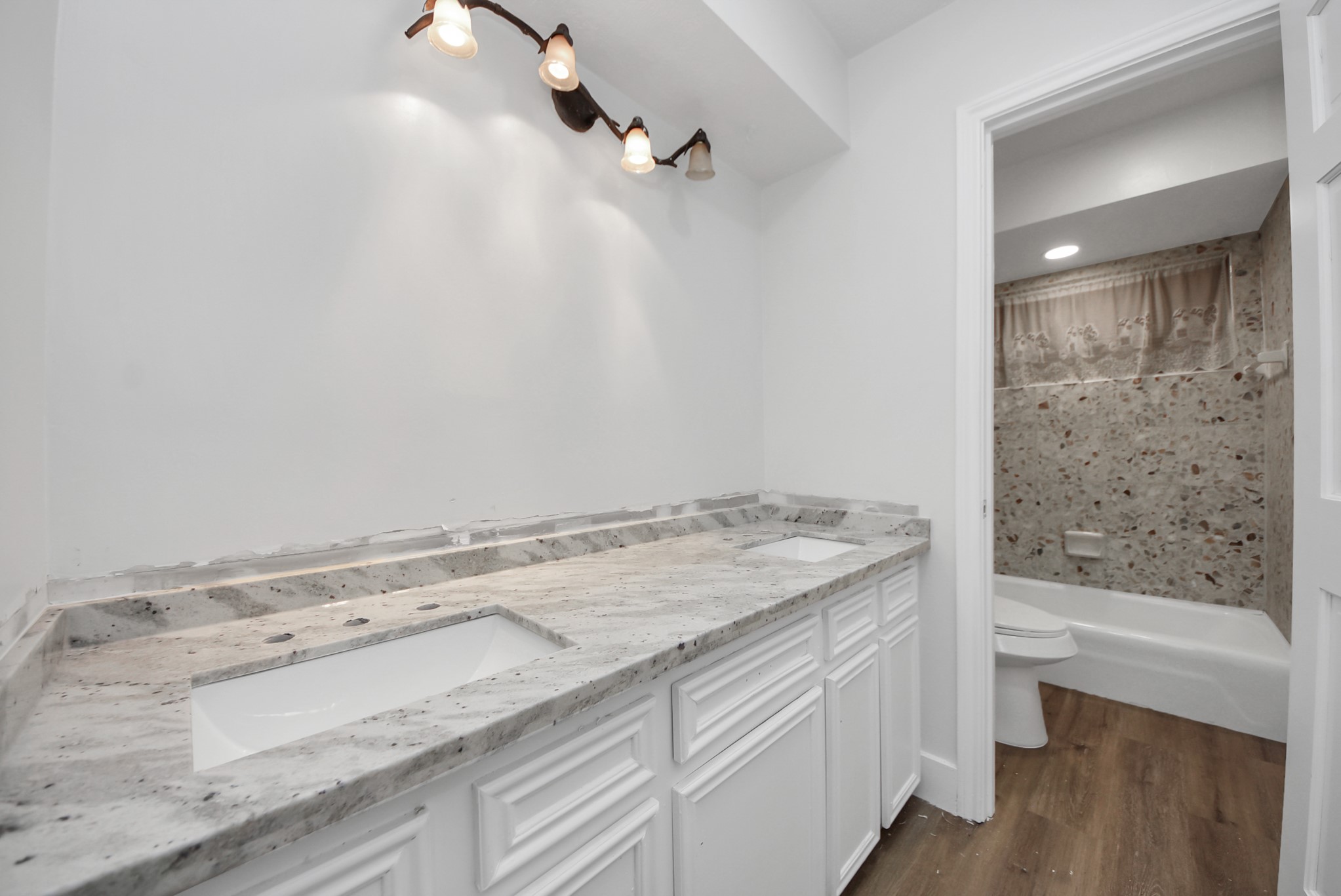 8111 Oak Moss Drive Spring, TX 77379 - Photo 35 of 49 a bathroom with a granite countertop sink and a bathtub