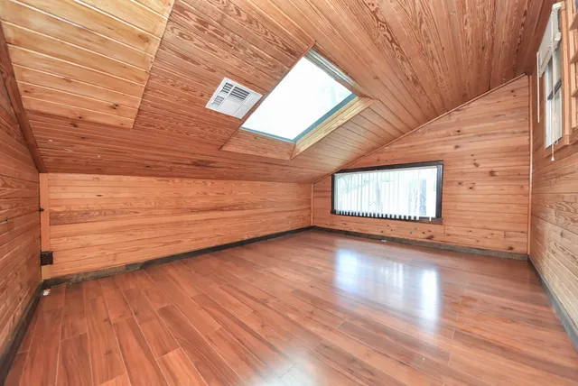 a view of a room with wooden floor