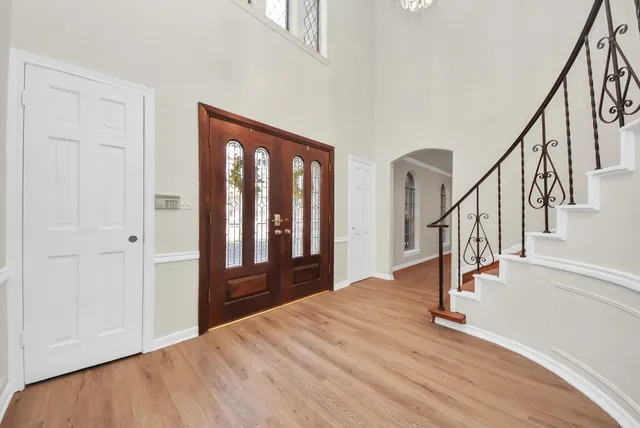 a view of an entryway with wooden floor and staircase