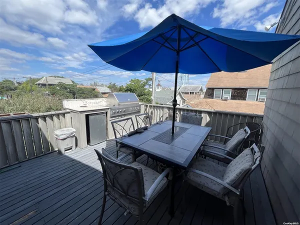 a view of a patio with wooden floor a yard