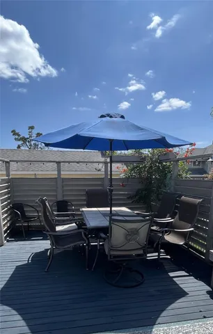 a roof deck with table and chairs