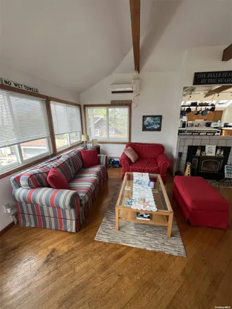 a living room with furniture a flat screen tv and a couch