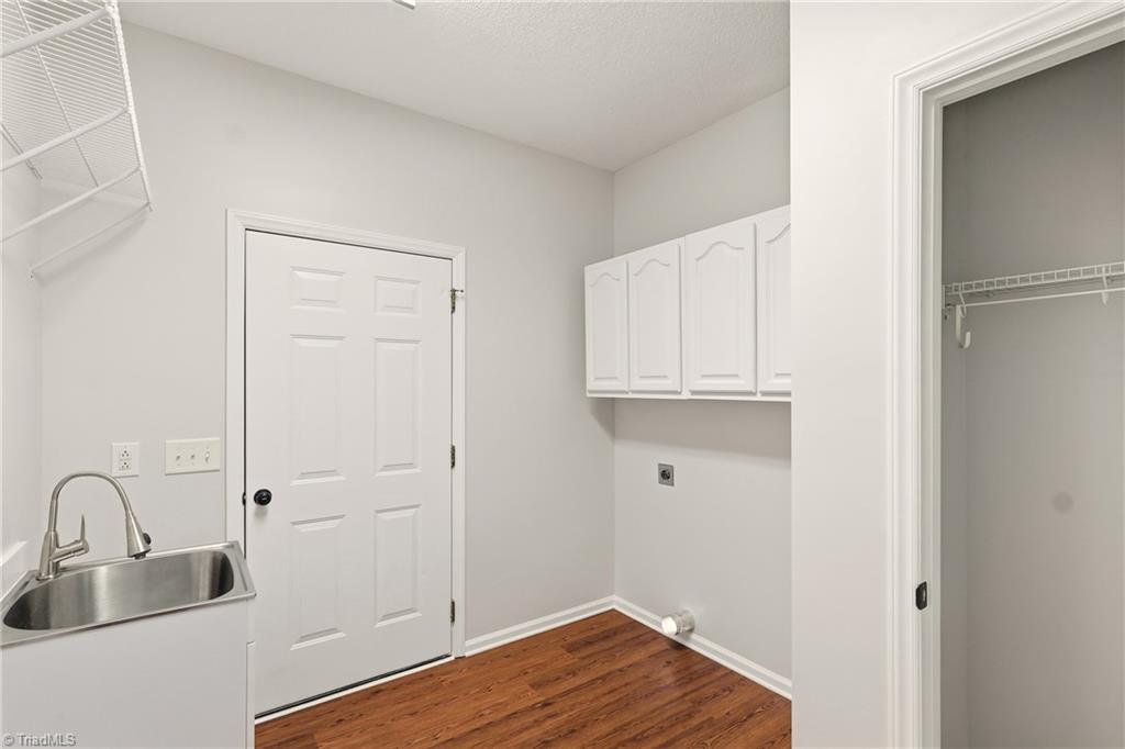 2166 Glen Cove Way High Point, NC 27265 - Photo 26 of 41 Walk in laundry room with overhead cabinet for storage and sink.